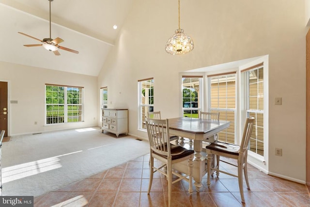  - dining space with high vaulted ceiling, a chandelier, light tile patterned flooring, light colored carpet, and a ceiling fan