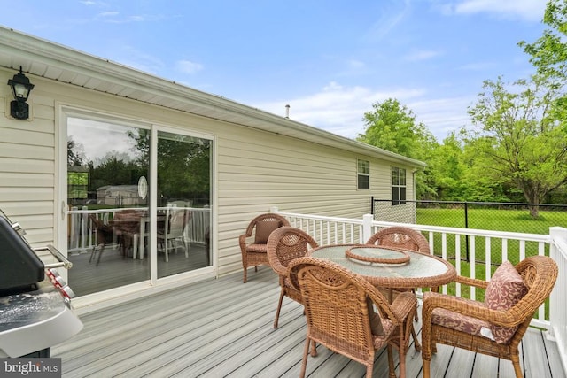  - deck with a yard and outdoor dining area