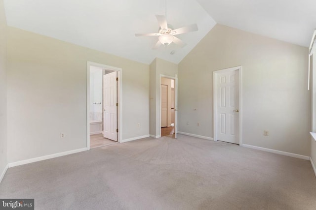  - unfurnished bedroom with light carpet, connected bathroom, a ceiling fan, and high vaulted ceiling