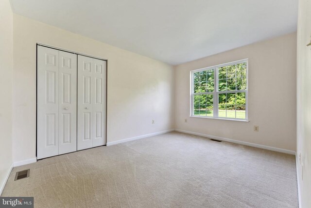  - unfurnished bedroom with carpet and a closet