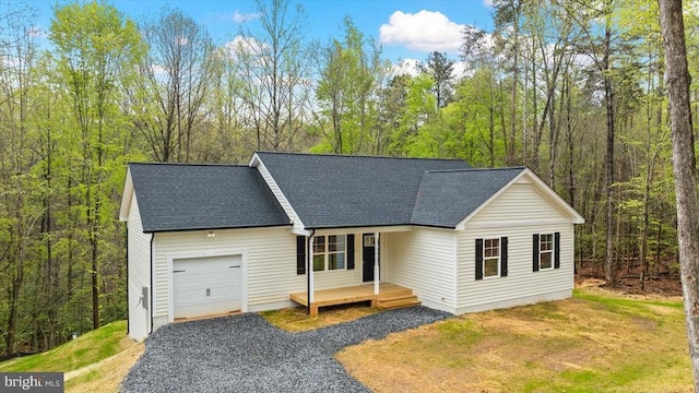 358 Hemlock Ln, Mineral, VA 23117 - view of front of home with an attached garage, gravel driveway, roof with shingles, and a forest view