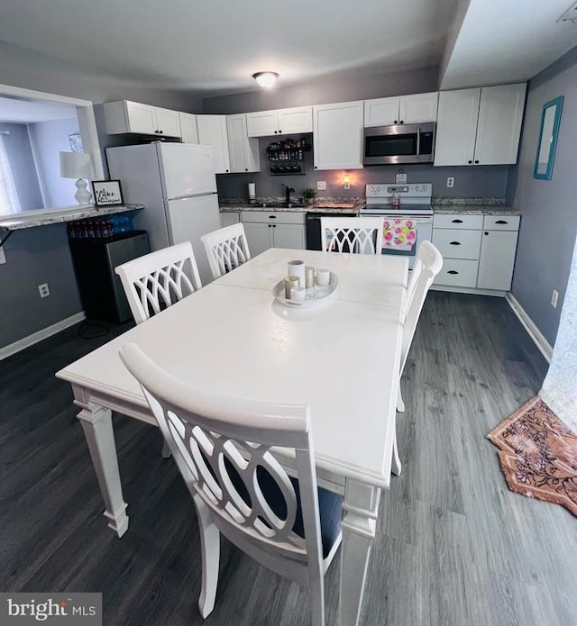 5122 Cottonwood Ct, Fredericksburg, VA 22407 - dining space with baseboards and dark wood-style flooring