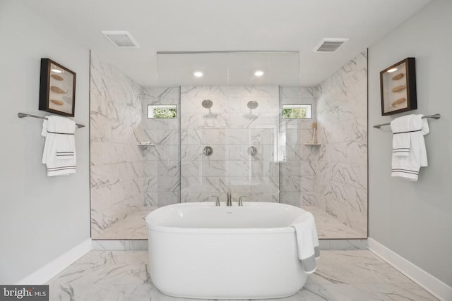  - bathroom with baseboards, marble finish flooring, a freestanding tub, and recessed lighting