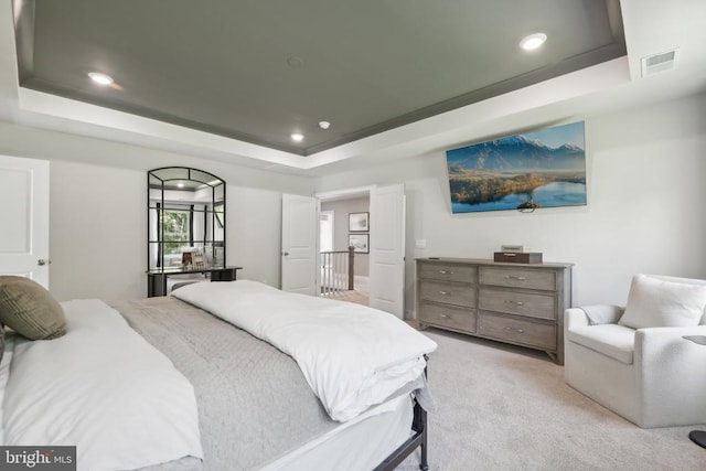  - bedroom featuring a tray ceiling, light colored carpet, and recessed lighting