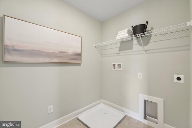  - washroom with electric dryer hookup, hookup for a washing machine, tile patterned flooring, and baseboards