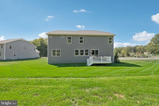  - back of house featuring a lawn