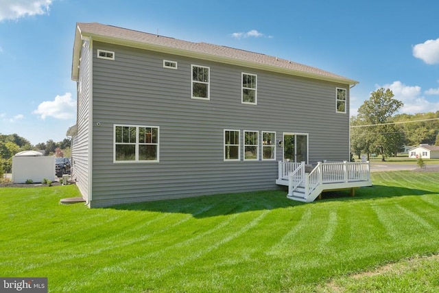  - back of house with a yard and a wooden deck