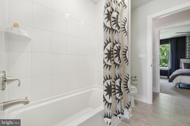  - ensuite bathroom featuring shower / tub combo, tile patterned flooring, toilet, and baseboards