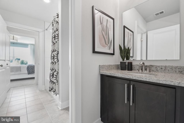  - ensuite bathroom with vanity, tile patterned floors, a shower with curtain, and baseboards