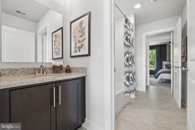  - ensuite bathroom with vanity, baseboards, shower / bathtub combination with curtain, and tile patterned flooring