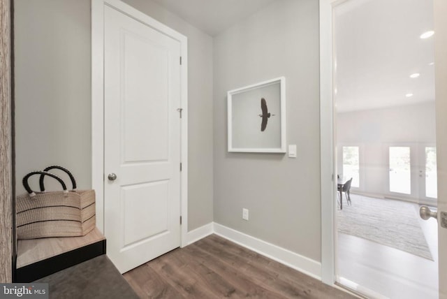  - hallway featuring dark wood finished floors, baseboards, recessed lighting, and french doors