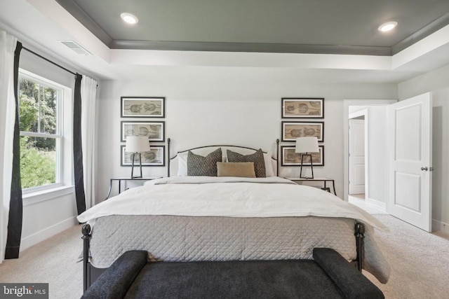 - bedroom with a raised ceiling, light colored carpet, baseboards, multiple windows, and recessed lighting