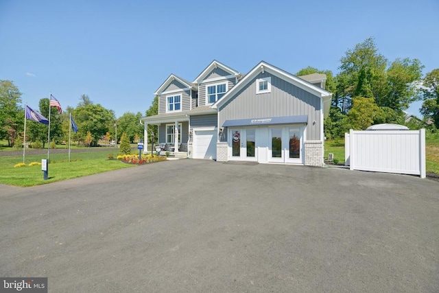  - view of front of home with a front lawn, driveway, and brick siding