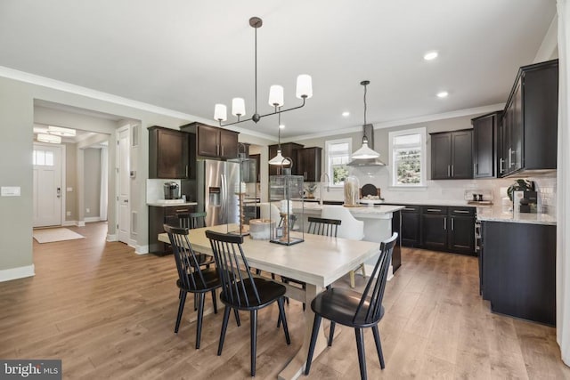  - dining room with ornamental molding, light wood finished floors, recessed lighting, and baseboards