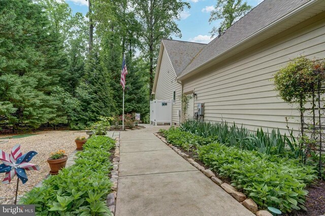 76 Retriever Ct, Bumpass, VA 23024 - view of side of home featuring an attached garage, asphalt driveway, and roof with shingles