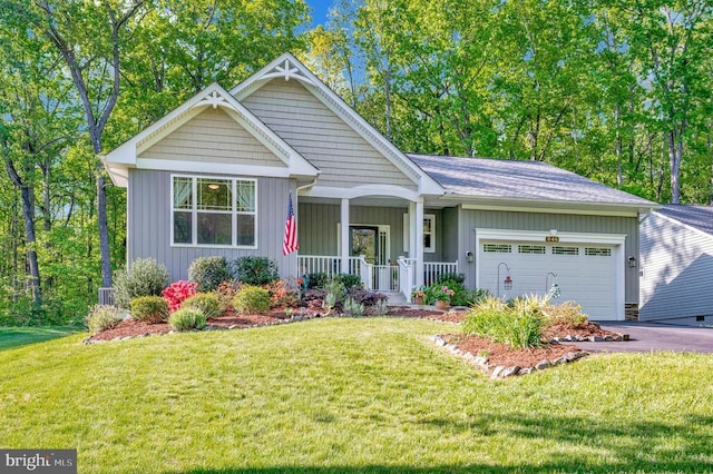 846 Confederate Dr, Locust Grove, VA 22508 - view of front of home with covered porch, aphalt driveway, a garage, a front lawn, and board and batten siding