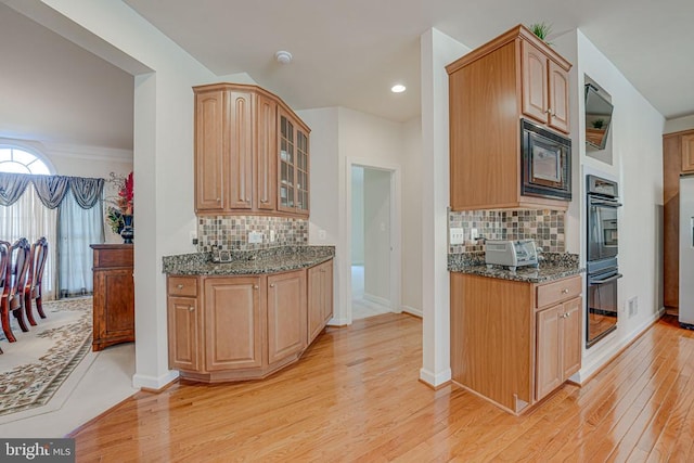 11512 Balmartin Ct, Spotsylvania, VA 22553 - kitchen with black appliances, light wood-style floors, dark stone counters, backsplash, and recessed lighting