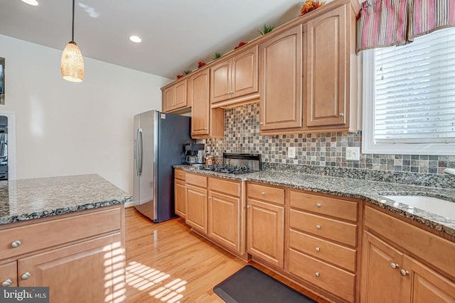 11512 Balmartin Ct, Spotsylvania, VA 22553 - kitchen with freestanding refrigerator, a sink, light wood-style floors, black cooktop, and dark stone counters