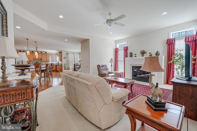 11512 Balmartin Ct, Spotsylvania, VA 22553 - living area featuring healthy amount of natural light, recessed lighting, ceiling fan, a glass covered fireplace, and light wood finished floors
