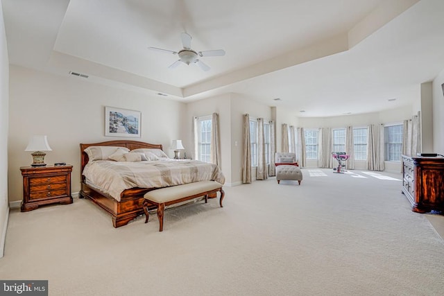 11512 Balmartin Ct, Spotsylvania, VA 22553 - carpeted bedroom featuring a tray ceiling, multiple windows, baseboards, and a ceiling fan