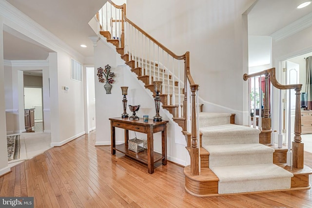 11512 Balmartin Ct, Spotsylvania, VA 22553 - stairway featuring wood-type flooring, crown molding, baseboards, recessed lighting, and a towering ceiling
