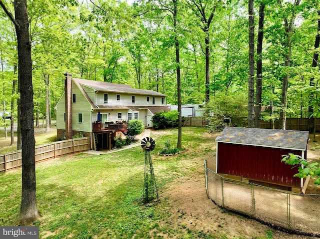 9128 Woodbrook Ln, Culpeper, VA 22701 - view of yard with a deck, an outdoor structure, and a wooded view