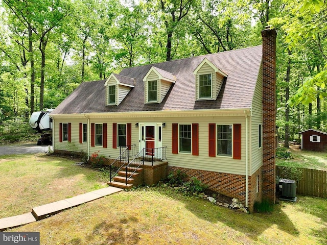 9128 Woodbrook Ln, Culpeper, VA 22701 - new england style home featuring central AC unit, a chimney, and view of wooded area