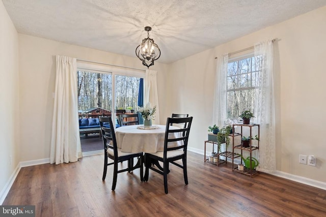9128 Woodbrook Ln, Culpeper, VA 22701 - dining area featuring dark wood-style floors, baseboards, a chandelier, and a textured ceiling