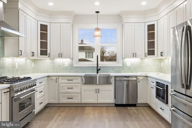 57 Madison St, Warrenton, VA 20186 - kitchen with stainless steel appliances, a sink, wall chimney range hood, light countertops, and white cabinets