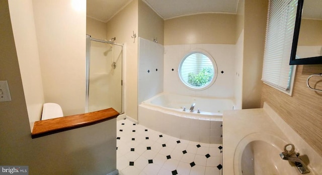 bathroom with a shower stall, a bath, and ornamental molding