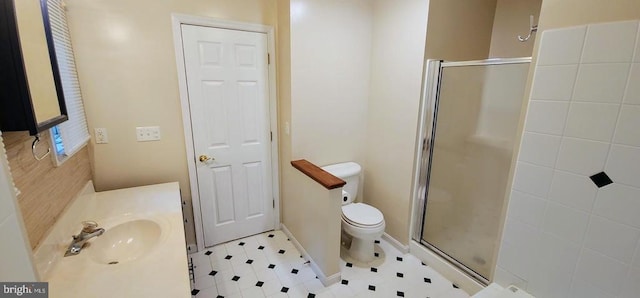 full bathroom with a stall shower, toilet, and vanity