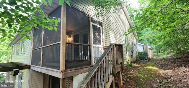 view of side of property with a sunroom and central AC unit