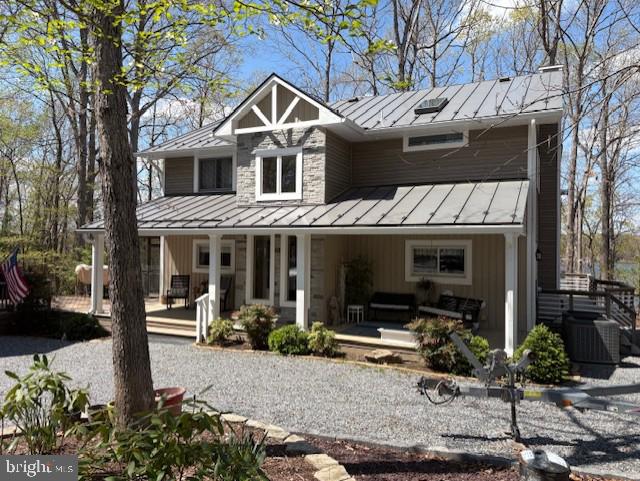 view of front of property featuring a porch, a standing seam roof, and metal roof
