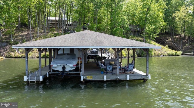 dock featuring boat lift and a water view