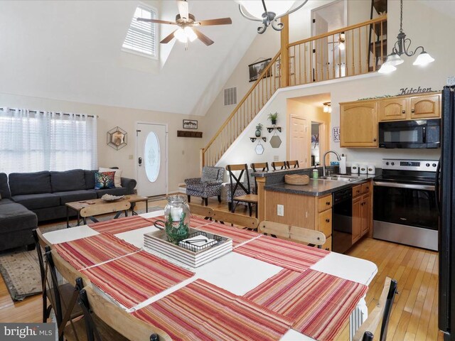 317 Locustdale Loop, Shenandoah, VA 22849 - dining area featuring high vaulted ceiling, ceiling fan, healthy amount of natural light, light wood-style floors, and stairs