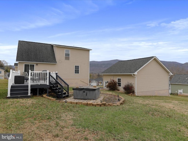 317 Locustdale Loop, Shenandoah, VA 22849 - rear view of house with a hot tub, a deck with mountain view, a yard, and roof with shingles