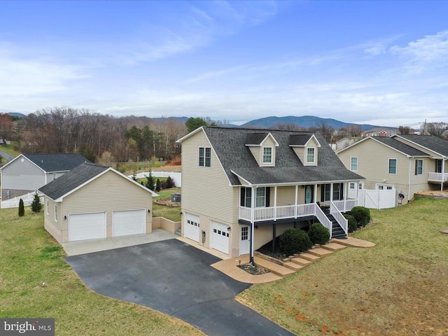 317 Locustdale Loop, Shenandoah, VA 22849 - view of front of house with a porch, a garage, asphalt driveway, a mountain view, and a shingled roof