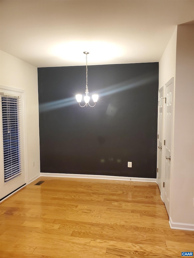 139 Longwood Dr, Charlottesville, VA 22903 - unfurnished room with a heating unit, a chandelier, light wood-type flooring, and baseboards