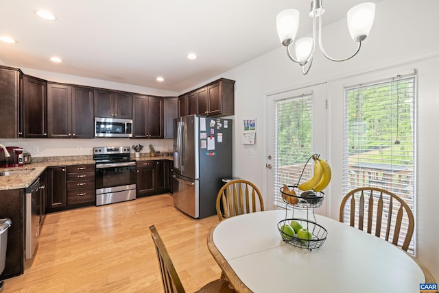 139 Longwood Dr, Charlottesville, VA 22903 - kitchen with stainless steel appliances, a sink, dark brown cabinets, light wood finished floors, and a chandelier