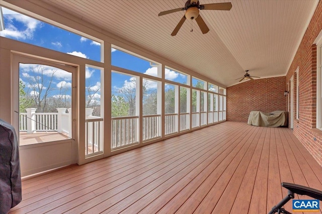1660 Lees Mill Ln, Goode, VA 24556 - unfurnished sunroom featuring ceiling fan, brick wall, hardwood / wood-style flooring, and vaulted ceiling