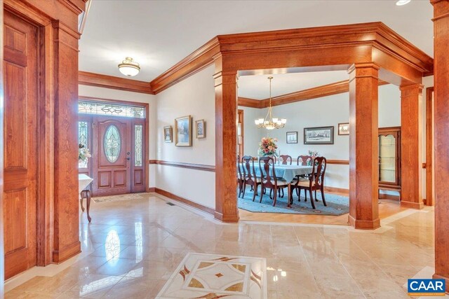 1660 Lees Mill Ln, Goode, VA 24556 - foyer with ornate columns, ornamental molding, baseboards, a chandelier, and light marble finish flooring