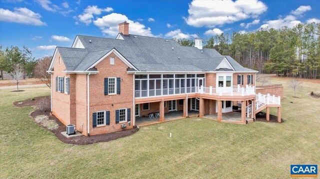 1660 Lees Mill Ln, Goode, VA 24556 - back of property with brick siding, a chimney, a sunroom, and central AC