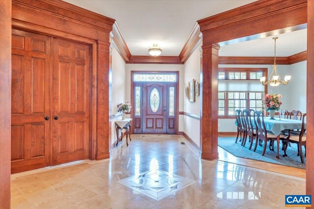 1660 Lees Mill Ln, Goode, VA 24556 - entryway with ornamental molding, healthy amount of natural light, a chandelier, and baseboards