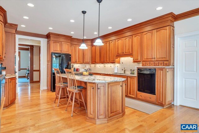 1660 Lees Mill Ln, Goode, VA 24556 - kitchen with light wood-style flooring, light stone countertops, freestanding refrigerator, tasteful backsplash, and brown cabinets