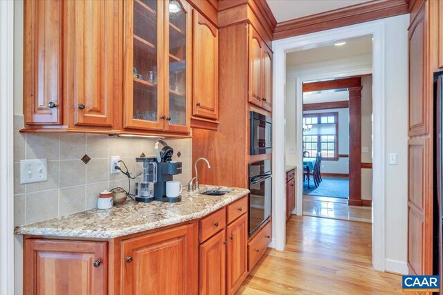 1660 Lees Mill Ln, Goode, VA 24556 - kitchen featuring black appliances, brown cabinetry, and backsplash