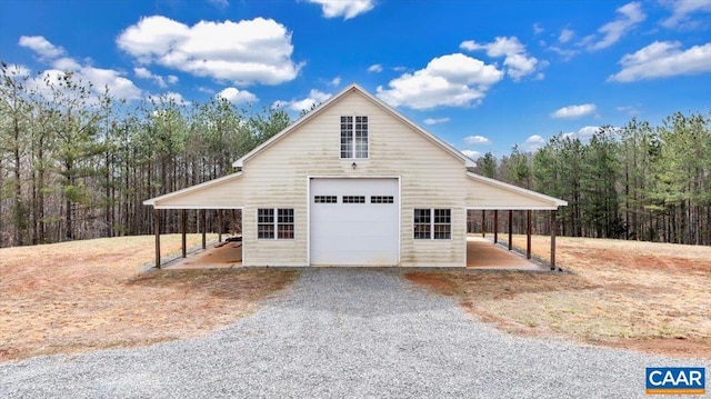 1660 Lees Mill Ln, Goode, VA 24556 - view of side of home with a garage, a view of trees, and gravel driveway