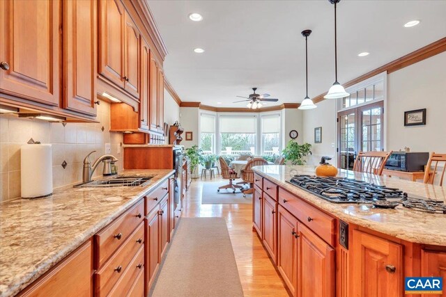 1660 Lees Mill Ln, Goode, VA 24556 - kitchen featuring a sink, ornamental molding, gas stovetop, plenty of natural light, and light wood-style flooring
