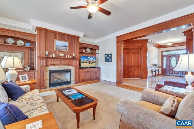 1660 Lees Mill Ln, Goode, VA 24556 - living room with ornamental molding, ceiling fan, a premium fireplace, baseboards, and decorative columns
