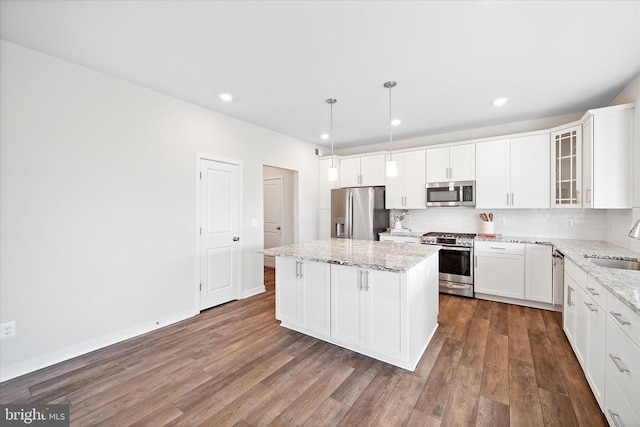 2093 Whithorn Hl, Jeffersonton, VA 22724 - kitchen with stainless steel appliances, a kitchen island, dark wood-type flooring, backsplash, and glass insert cabinets