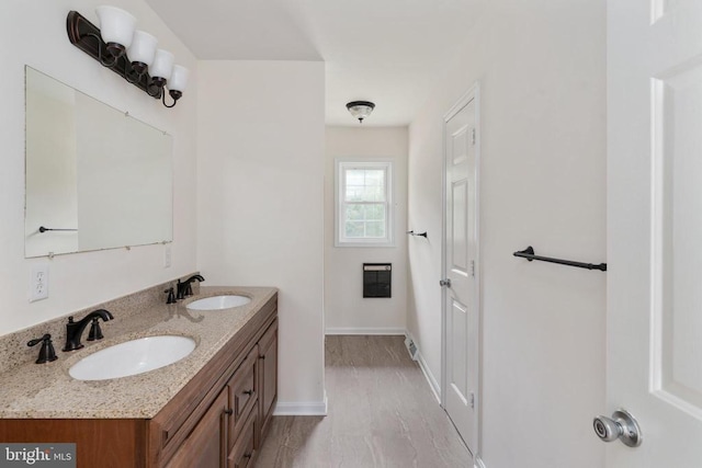 19253 Rolling Hills Dr, Culpeper, VA 22701 - bathroom with double vanity and wood finished floors